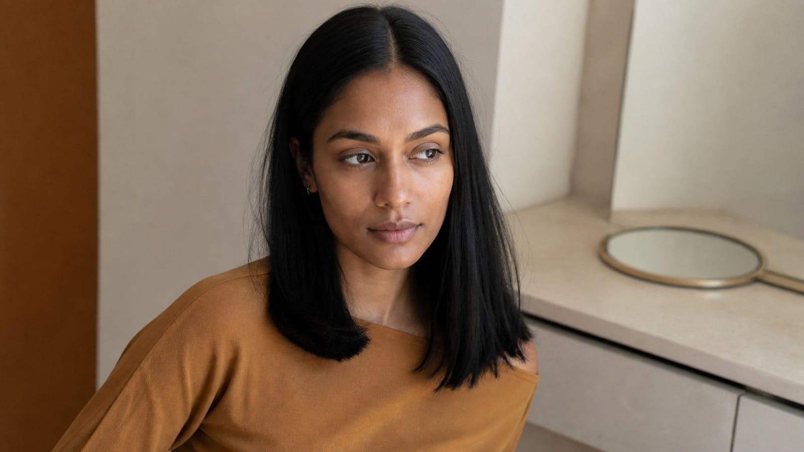 Diamond-like face with exact center part, open forehead, quiet side volume, and straight black hair ending below the shoulders